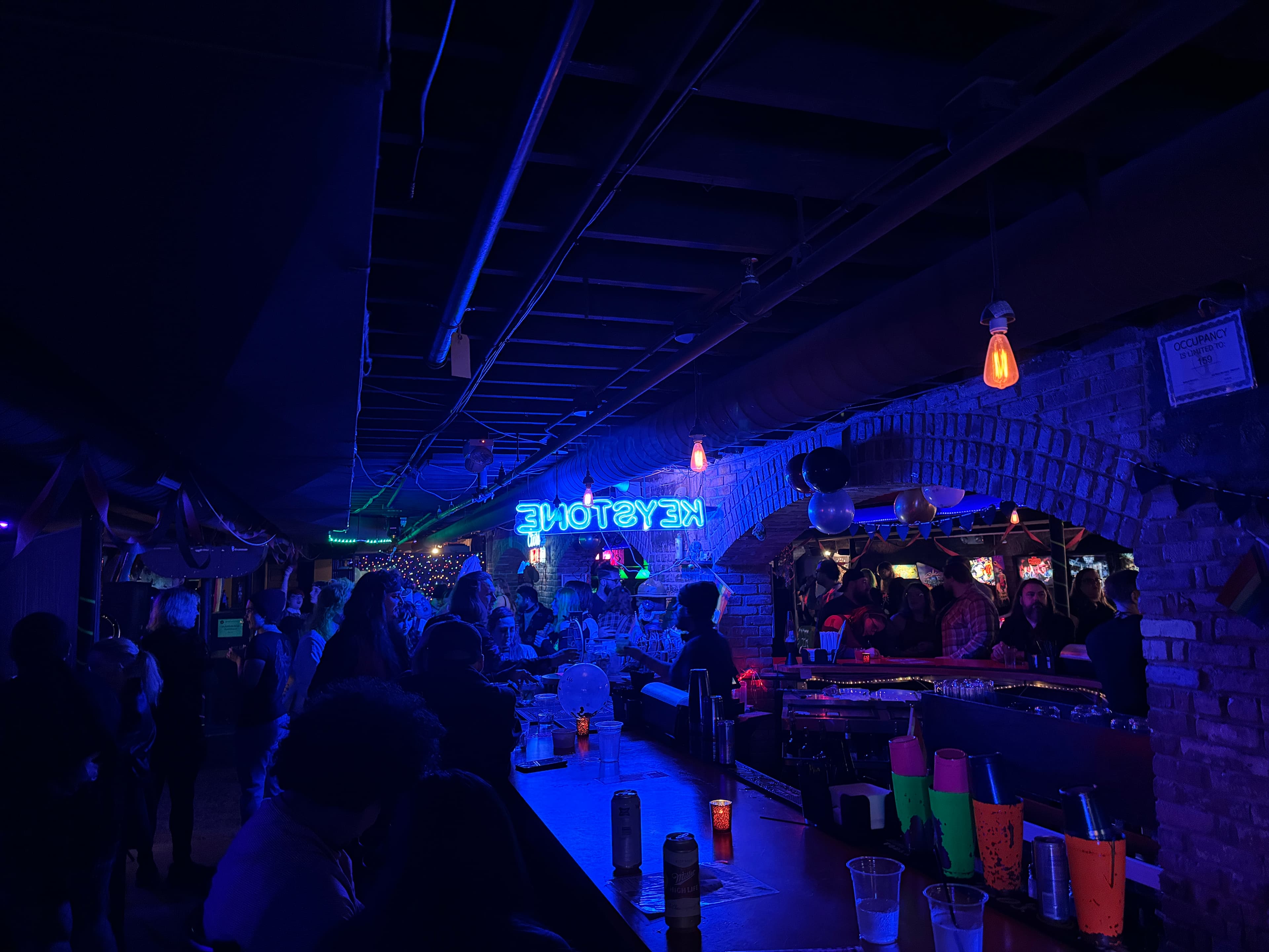 Busy nightclub full of people mingling.