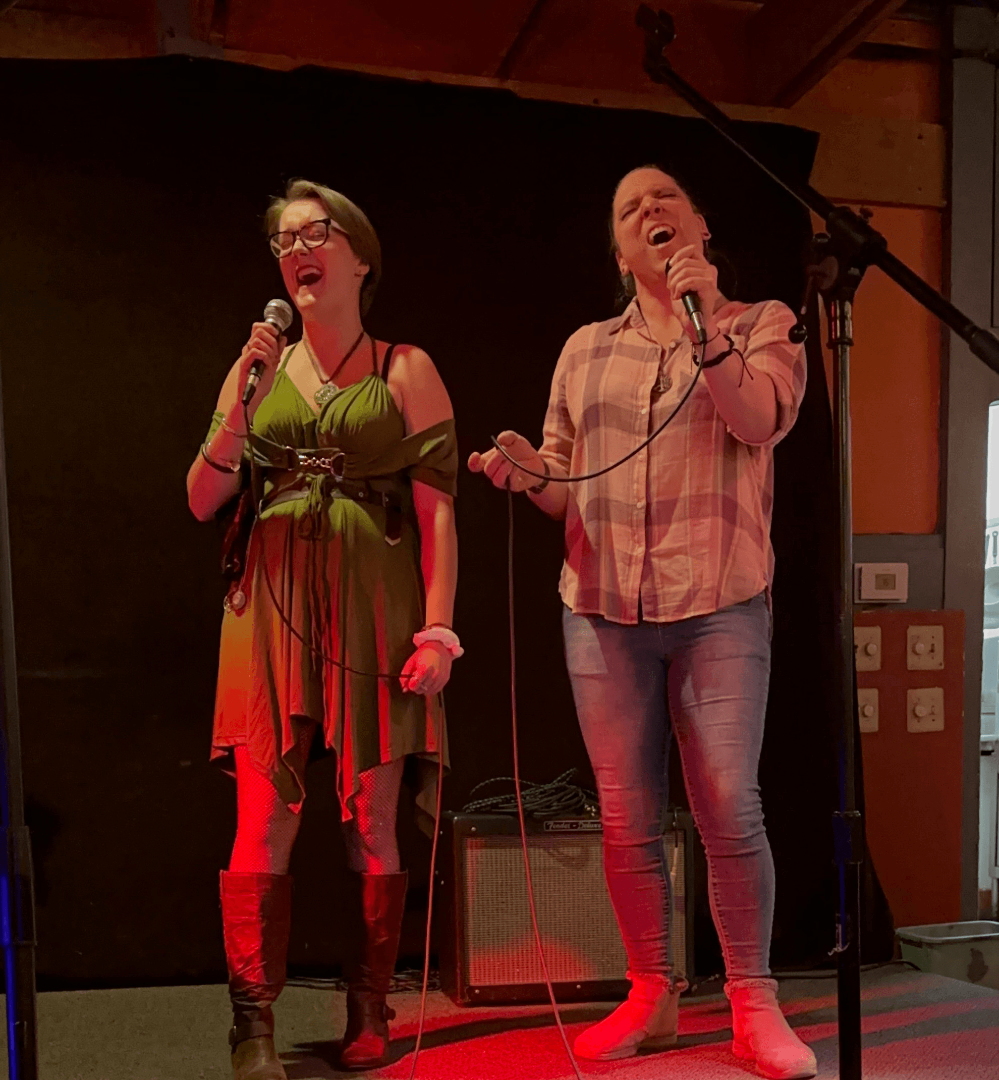 Two women singing on stage.