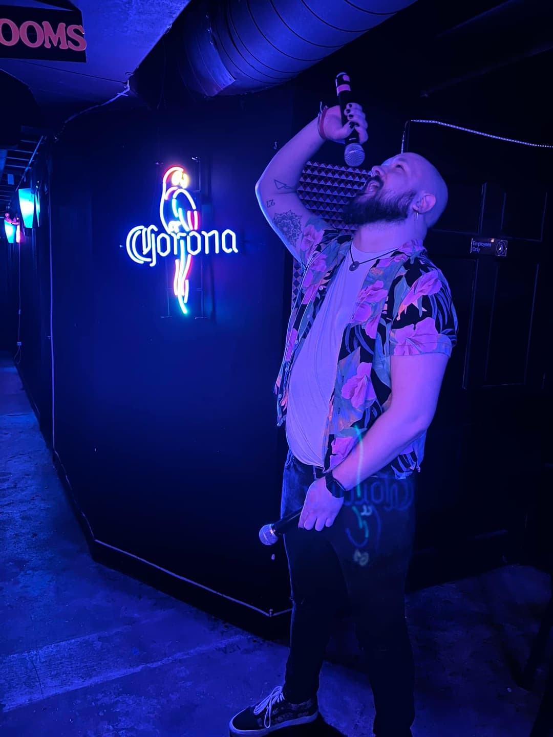 DJ Dan, a man, standing and screaming into a microphone.